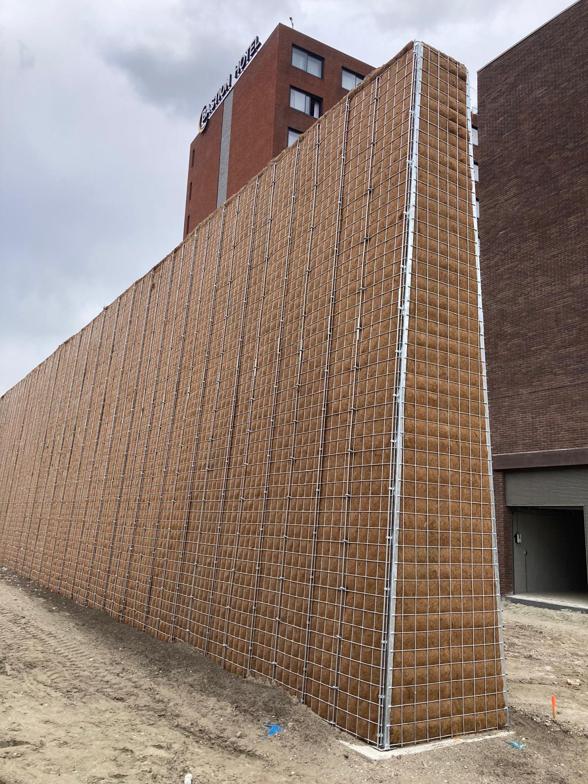 Tall unplanted Greenwall Construct acoustic barrier showing its galvanised steel frame and natural fill