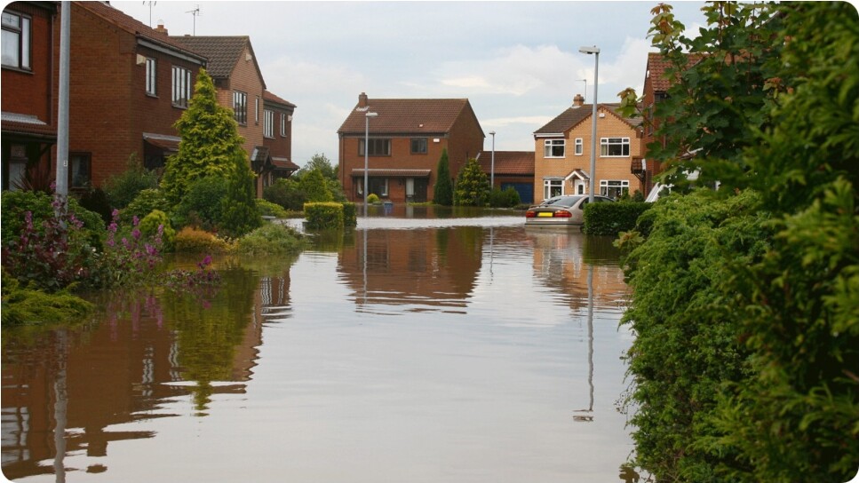 Flood water surrounding homes on a residential street